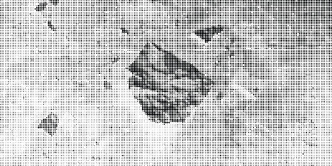 A rugged mountain stands prominently on a vast, barren, rocky landscape with scattered debris and a distant view. © Siddik