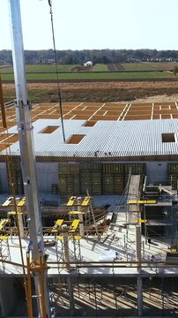 Ascending over warehouse construction site in middle of nowhere