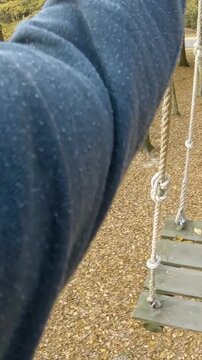 Adventure park walk between wooden hanging planks person POV