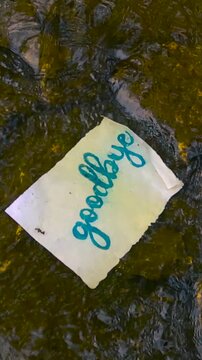Goodbye Letter Floating on a River Symbolizing Letting Go, Farewell, and the End of a Relationship