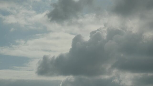 Dramatic storm clouds gathering above calm sea near Playa El Arbeyal Spain, natural backdrop