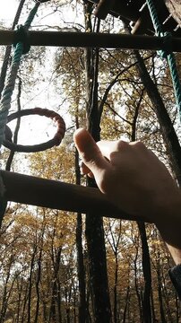 Climbing the rope ladder on tree person POV
