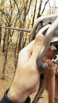 Person POV zip-line between trees at adventure park