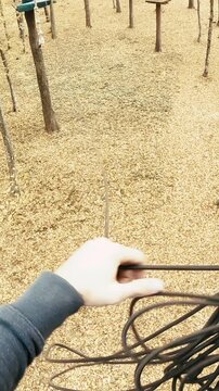 Person POV pull the rope on adventure park course