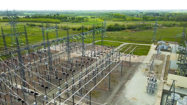 Aerial View of High Voltage Electrical Substation with Transformers and Power Lines in the Countryside