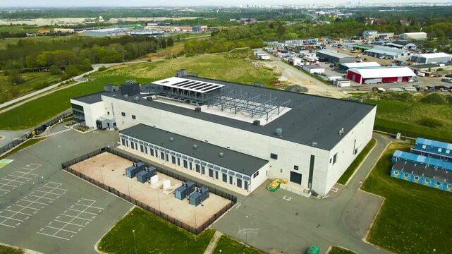Aerial View of a Modern Data Center with AI Cloud Computing Infrastructure and Servers in a Green Technology Park