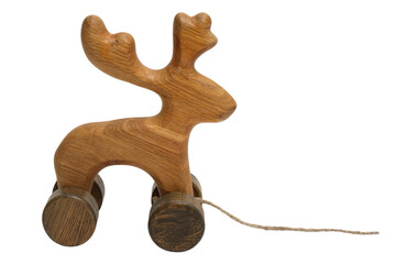 Fototapeta premium Wooden reindeer pull toy on wheels isolated on transparent background. Vintage handcrafted organic material animal figure for child play. Classic nursery decor and celebration gift.