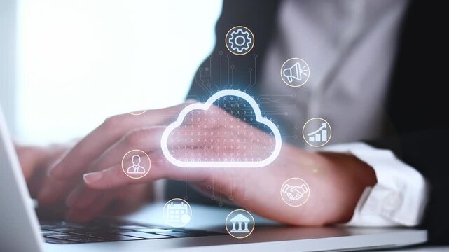 Working on a laptop with cloud computing icons and data signals during a business task in an office setting.