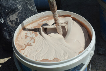 Mixing Paint for Wall Painting © bildlove