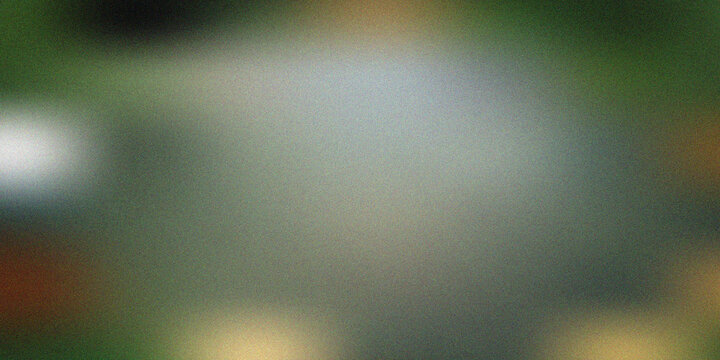 Abstract blurred background featuring a soft gradient of dark green and grey tones with a subtle grainy texture and glowing light spots, artistic backdrop.