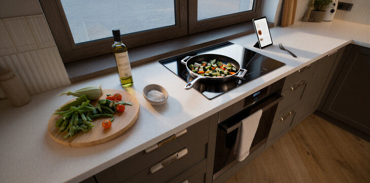 Cooking healthy vegetables in a skillet on modern kitchen stovetop with culinary
