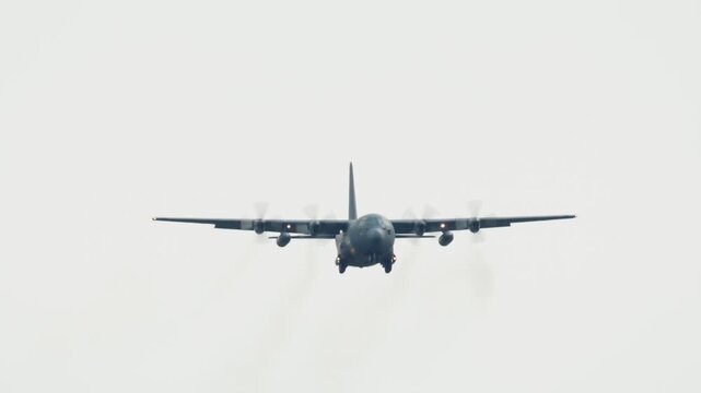 C-130 Hercules Tactical Airlift Aircraft Flying in Cloudy Sky
