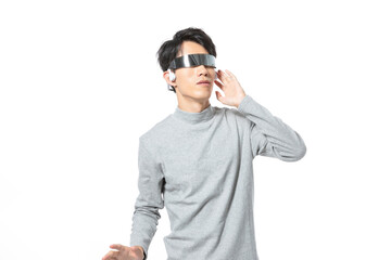 Fototapeta premium Young Man Wearing Futuristic Smart Glasses and Earbud