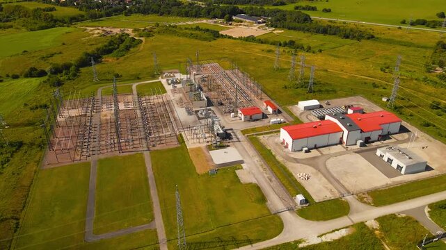 High voltage electrical substation and power plant for energy transmission. Aerial view of a distribution center supplying a data center