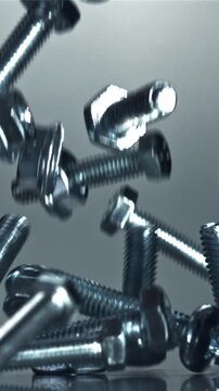 Falling nuts, bolts and washers on a metal table. Filmed on a high-speed camera at 1000 fps. High quality FullHD footage