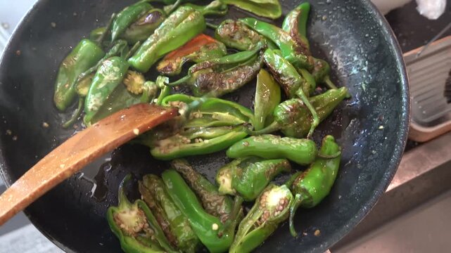 Stockholm, Sweden Fried green peppers with garlic and oil, salt and pepper.