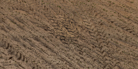 top view of gravel road surface with tractor tire tracks in countryside © hiv360
