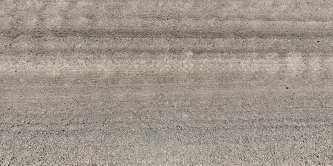 top view of gravel road surface with tractor tire tracks in countryside © hiv360