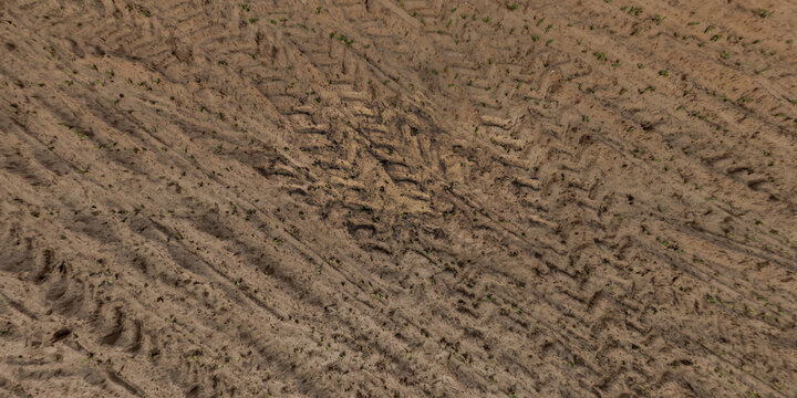 top view of gravel road surface with tractor tire tracks in countryside