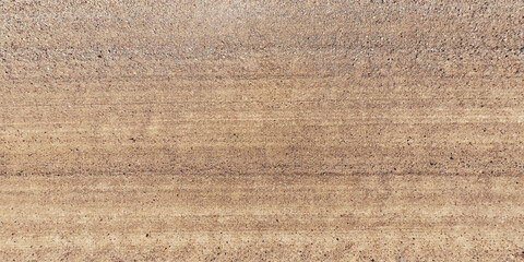 top view of gravel road surface with tractor tire tracks in countryside © hiv360