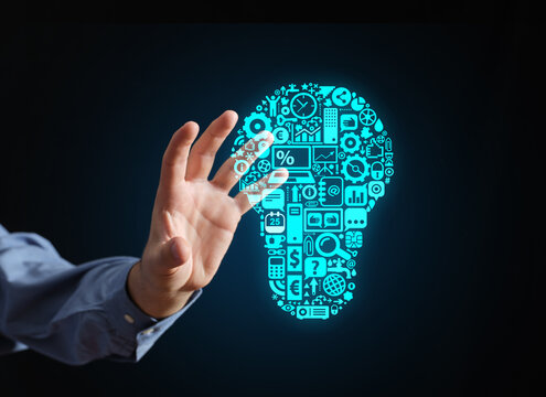 Hand holding creative business lightbulb with technology icons