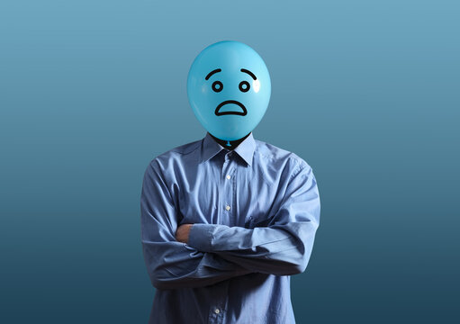 Man with balloon head having worried expression