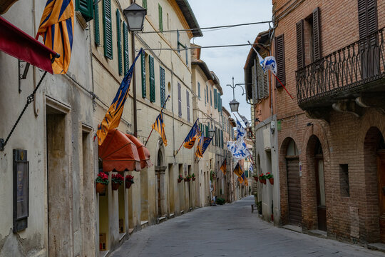 Street of Montalcino with flags, Tuscany, Italy