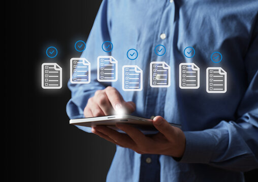 Businessperson completing tasks with digital checklist on tablet