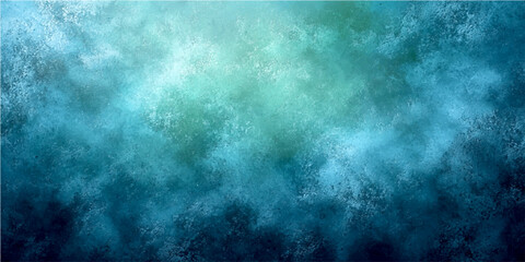 Fototapeta premium Abstract blue and green textured background with light effect in upper part and dark blue in lower part.