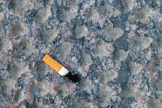 cigarette butt on walkway stone outdoors
