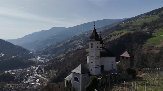 Forward Drone Flight Alongside Church Dome Over Vineyards in Chiusa, South Tyrol, Italian Alps