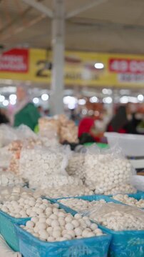 Traditional Uzbek bazaar stall selling kurt, a popular dried fermented dairy snack, displayed in large quantities at an authentic local marketplace in Uzbekistan. Traditional food market