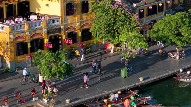 Aerial panoramic view of Hoi An city, Da Nang province, Vietnam. Pedicabs carrying tourists for sightseeing in the old town, UNESCO world heritage. One of the most travel popular touristic destination