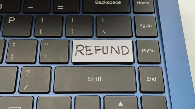 Key with refund word written on laptop computer keyboard.  Ecommerce business service, online purchase, shopping payment and product return policy concept. Closeup top spinning or rotation view.