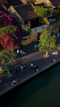 Aerial panoramic view of Hoi An city, Da Nang province, Vietnam. Pedicabs carrying tourists for sightseeing in the old town, UNESCO world heritage. One of the most travel popular touristic destination