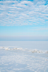 Expansive arctic winter landscape with frozen ice and pristine white snow under a clear blue sky