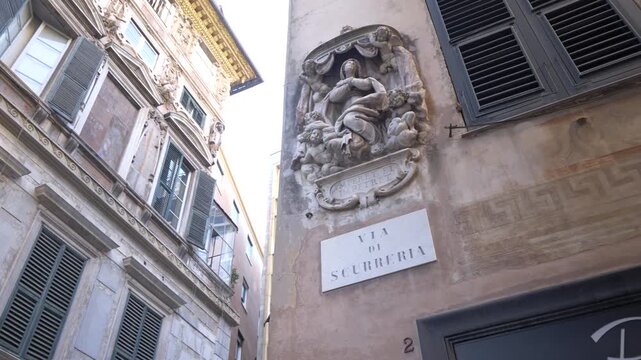 Votive aedicule on historic building facade, Genoa old town, Italy