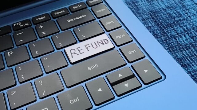 Closeup of customer press, push or click key with refund word written on laptop computer keyboard. Digital ecommerce business service online purchase and shopping payment product return policy concept