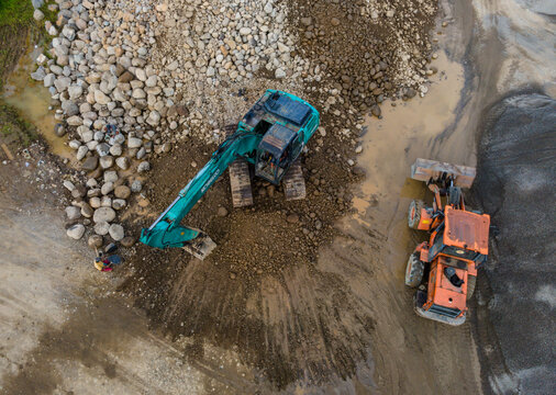 Kobelco Excavator, Workers and Bulldozer in Rock and Sand Quarry, Mining Site from Above on May 25, 2026 in Purwokerto, Central Java, Indonesia 