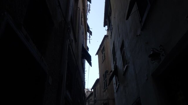 Dark narrow alley in Genoa historic center, Italy