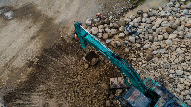 Kobelco Excavator and Workers in Rock and Sand Quarry, Mining Site from Above on May 25, 2026 in Purwokerto, Central Java, Indonesia 