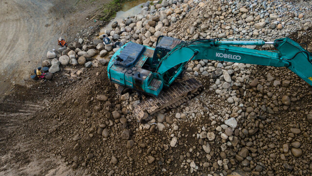 Kobelco Excavator and Workers in Rock and Sand Quarry, Mining Site from Above on May 25, 2026 in Purwokerto, Central Java, Indonesia 