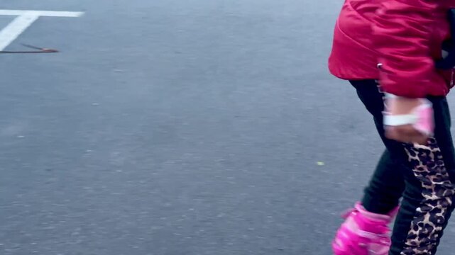 Low angle view of person inline skating on asphalt ground