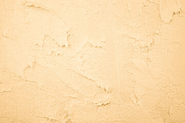 Fototapeta premium Pale yellow plaster wall texture with rough surface