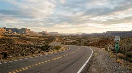 Fotobehang Wit Scenic Route 66 Highway Winding Through Arid Desert Landscape at Sunset.  © dewi