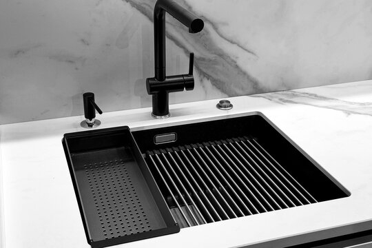 Modern black kitchen sink with faucet and drainer