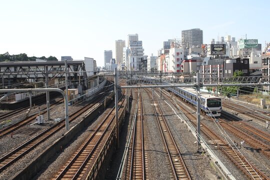 High angle view of multiple railway tracks and a running train in Tokyo.