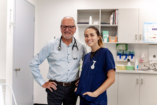 Doctor and nurse standing in treatment room with medical supplies