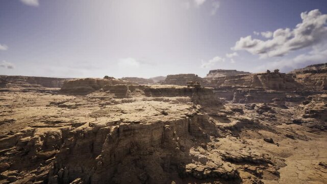 golden rugged canyon under bright sky, low angle light casting long shadows, textured sandstone foreground and wide vista for travel and editorial storytelling