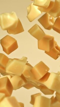 Cubes of maasdam cheese fly on a light background. Filmed on a high-speed camera at 1000 fps. High quality FullHD footage